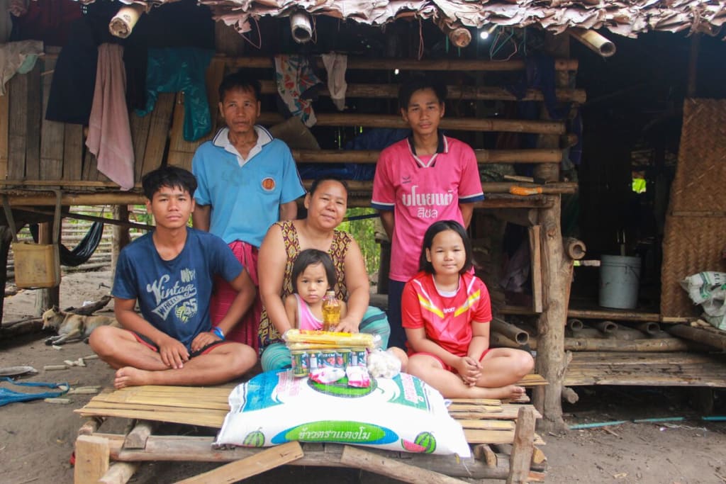Family of 6 smiles together in front of their food delivery